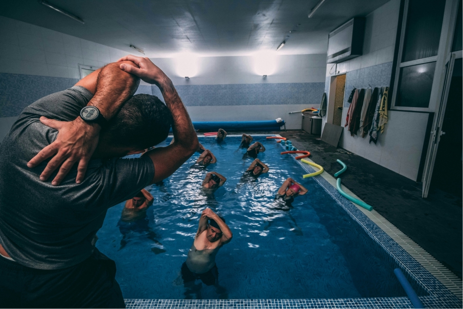 Swim instructor coaching students in a pool